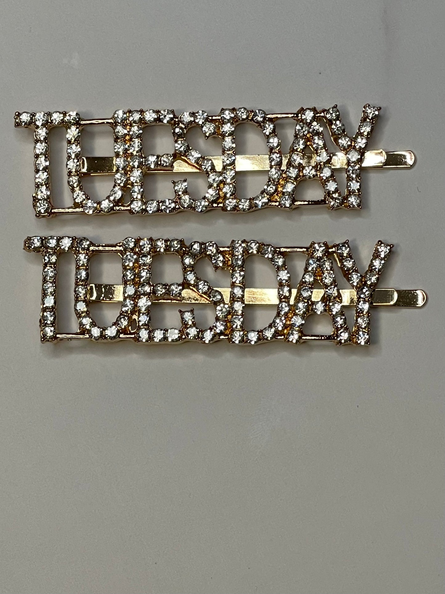 Gold Metal Crystal Hair Pin that reads TUESDAY